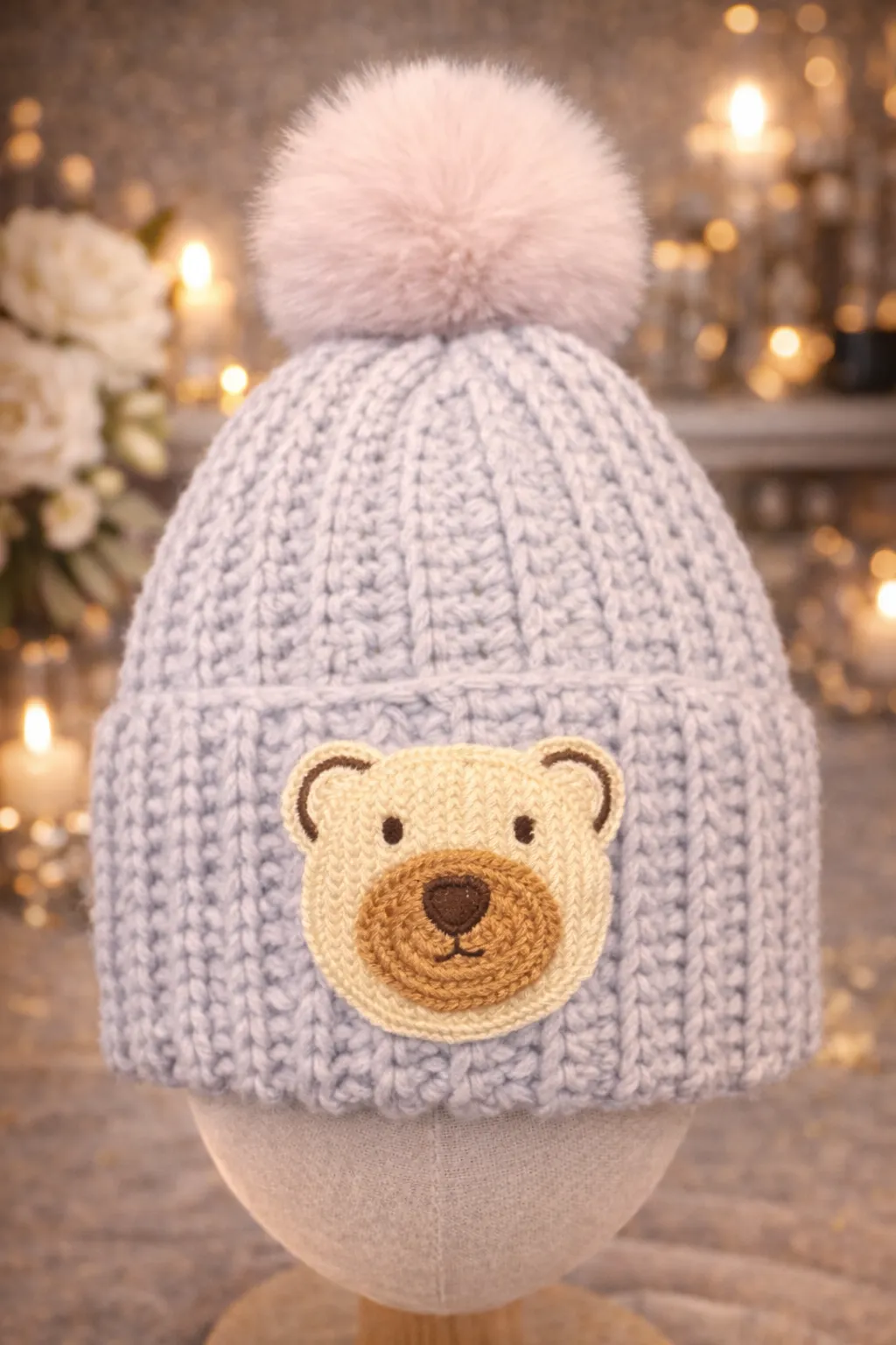 Lilac baby beanie with a small bear.
