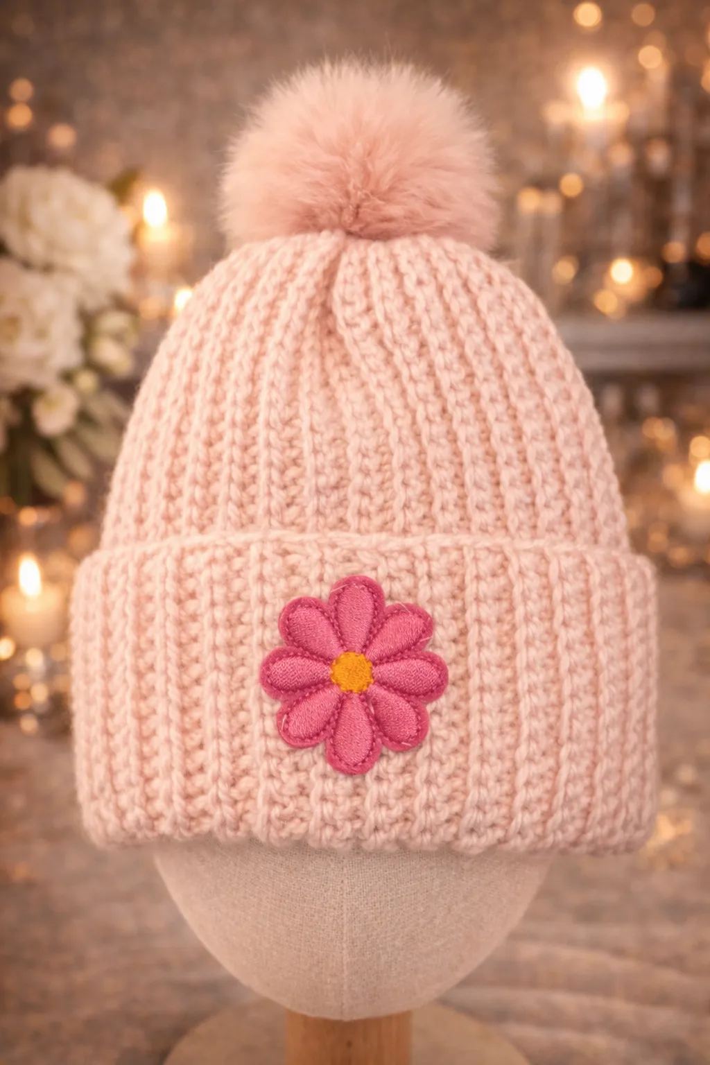 Pink kids beanie with a crocheted flower.